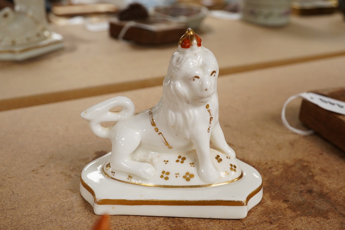 A Staffordshire lion with crown, c.1830-50 and a Staffordshire slipware cat, largest 8.5cm high (2)